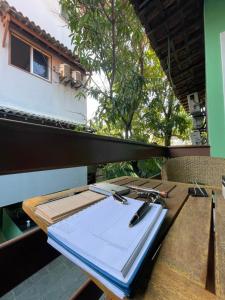 a wooden table with a notebook and pens on it at Enjoy suítes in Aracaju