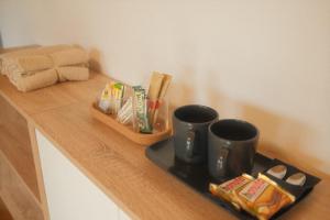 a counter with two coffee cups and snacks on it at Pension am Waldrand in Sinsheim