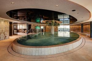 a pool in the middle of a building at Lake Spa Hotel SEELEITEN in Caldaro