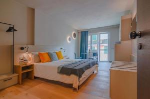 a bedroom with a bed and a large window at Ca' De Carme' in Riomaggiore