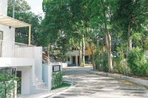 a street in front of a house with trees at Tiny home Pana B Private residence 10mins beach in Bophut