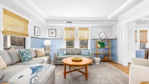 a living room with a couch and a table at 5BR plus Den - Downtown OC - Sleeps 16 in Ocean City +41 photos