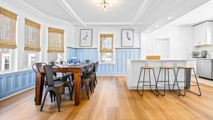 a dining room with a table and chairs in a kitchen at 5BR plus Den - Downtown OC - Sleeps 16 in Ocean City