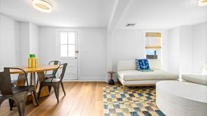 a living room with a table and a couch at 5BR plus Den - Downtown OC - Sleeps 16 in Ocean City