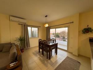 a living room with a couch and a table with chairs at Zowaar homes in Dahab