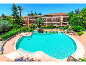 a large swimming pool in front of a building at Beautiful 36m2 studio apartment & 50m2 terrace in Cannes