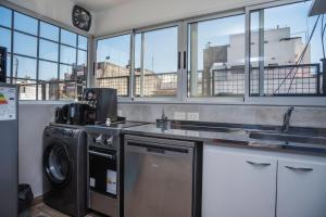 a kitchen with a sink and a washing machine at Departamento hasta 7 personas en Recoleta in Buenos Aires +19 photos