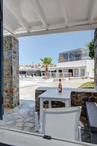 een witte tafel en stoelen op een patio bij Aegean Paradiso Vacation Club - "Adults Only" in Azolimnos