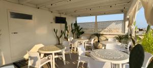 a group of tables and chairs on a balcony at Silvia Casa Vacanze in Porto Cesareo