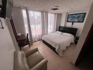 En eller flere senge i et værelse på Hotel Venecia Confort