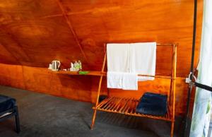 a room with a bench and towels in a tent at Ella Jungle Rock in Ella