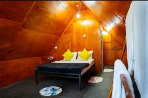 a bedroom with a bed in a wooden tent at Ella Jungle Rock in Ella