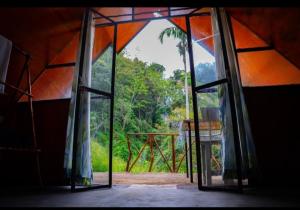 an open door to a tent with a view of a forest at Ella Jungle Rock in Ella