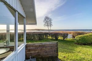 a house with a balcony with a view of the ocean at BLE885-Ramdala-Ormen-langes-vaeg-10 in Ramdala