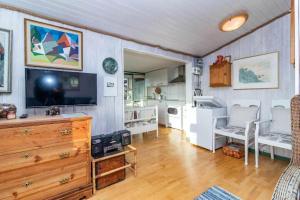 a living room with a television and a wooden dresser at BLE885-Ramdala-Ormen-langes-vaeg-10 in Ramdala