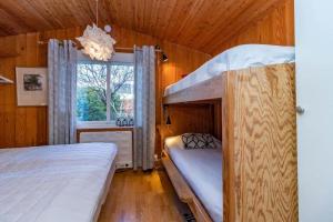 a bedroom with two bunk beds and a window at BLE885-Ramdala-Ormen-langes-vaeg-10 in Ramdala