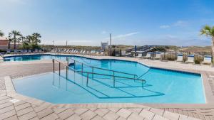 a large swimming pool with stairs in a resort at Phoenix East II 2032 in Orange Beach