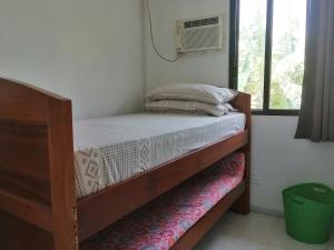 a bedroom with a bunk bed with a fan and a window at Silay Haven Near Airport by One Guest Place 3919B in Silay +26 photos