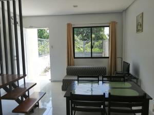 a living room with a table and a couch at Silay Haven Near Airport by One Guest Place 3919B in Silay