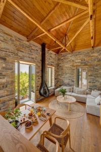 a living room with a brick wall at EJ Boutique Suites in Milina