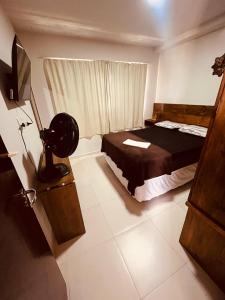 a bedroom with a bed and a window and a television at Condomínio Sonhos Da Serra in Bananeiras