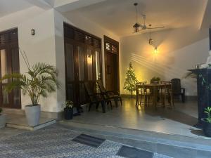 a living room with a table and chairs and a christmas tree at Villa Princess & Apartment in Hikkaduwa