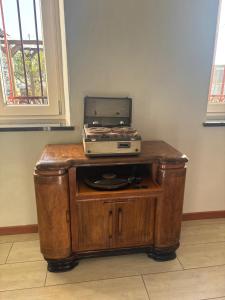 a radio on a wooden table with a laptop on top at Cascina Teresina Monferrato Piscina in Cortazzone