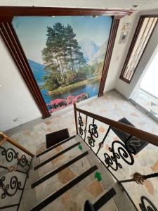 a staircase with a large window with a view of a lake at Hotel Venecia Confort in Pasto