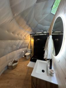a bathroom with a sink and a mirror in a tent at Bulle au Fil de l'eau in Romilly-sur-Andelle +28 photos
