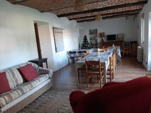a living room with a long table and a couch at Cascina Teresina Monferrato Piscina in Cortazzone