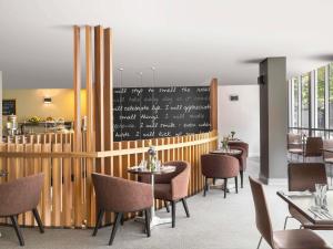 a restaurant with tables and chairs and a chalkboard at Mantra on Kent in Sydney