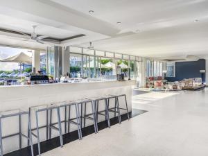 a lobby with a bar with stools at Mantra on Salt Beach in Kingscliff