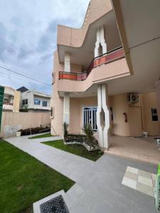 a house with a walkway in front of it at Hôtels Résidences Easy in Cotonou