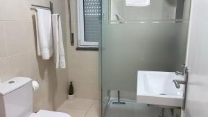 een witte badkamer met een toilet en een wastafel bij Casa Rosa in Parede