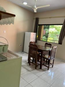 a kitchen with a table and chairs and a refrigerator at Departamentos a Pasos de la Basílica in Caacupé