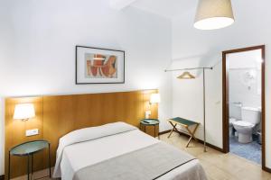 a hotel room with a bed and a toilet at Murças74 - Studio Apartments in Funchal