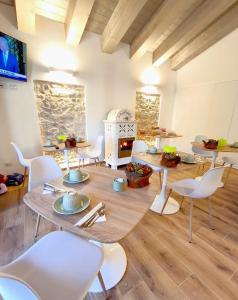 a dining room with tables and chairs and a fireplace at Maria Luisa Mountain Lodge in Rovere