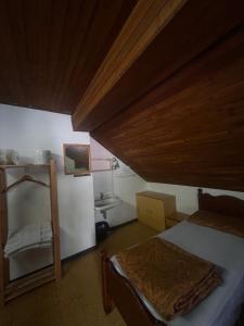 una piccola camera da letto con un letto e un lavandino di Rifugio La Capanna a Claviere Altre 23 foto