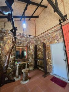 a room with a stone wall with a mirror at Pirates Bay Resort & Spa in Ko Lanta