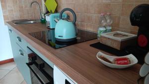 a kitchen counter with a tea kettle on it at LaelleApartament Rho Fiera San Siro in Cornaredo