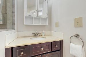 a bathroom with a sink and a mirror at Stowe Mountain Road Retreat in Stowe