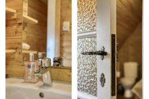 a bathroom with a sink and a door with a mirror at Le Chalet Rustique in Spa +29 photos