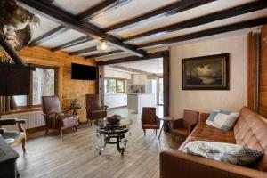 a living room with a couch and chairs at Le Chalet Rustique in Spa