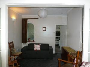 a living room with a couch and a table at Beautiful 'Rose-Dene' with ample parking in Sheerness +12 photos
