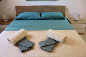 een bed met twee kussens en handdoeken erop bij Casa Stancarlino in Tricase +29 foto's