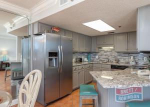 a large kitchen with a stainless steel refrigerator at Phoenix East II 2072 in Orange Beach