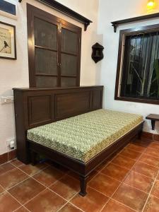 a bed sitting in a room next to a window at Junput Guest House in Bichania