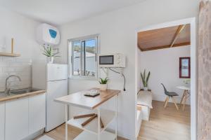 a kitchen with a white refrigerator and a table at Villa Star in Agaete