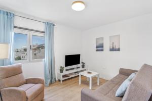 a living room with a couch and a tv at Villa Star in Agaete