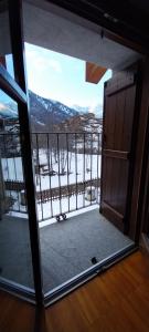 a door to a balcony with a view of the mountains at Rifugio Alevé in Castello